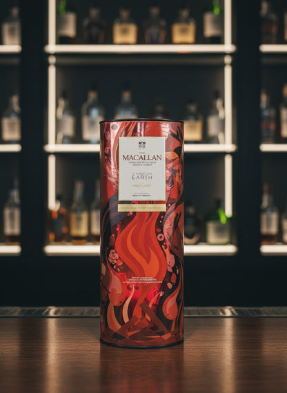 Whiskyquartier presents The Macallan A Night on Earth The First Light 2025 limited edition single malt Scotch whisky in a vibrant, fiery orange and brown illustrated tube.